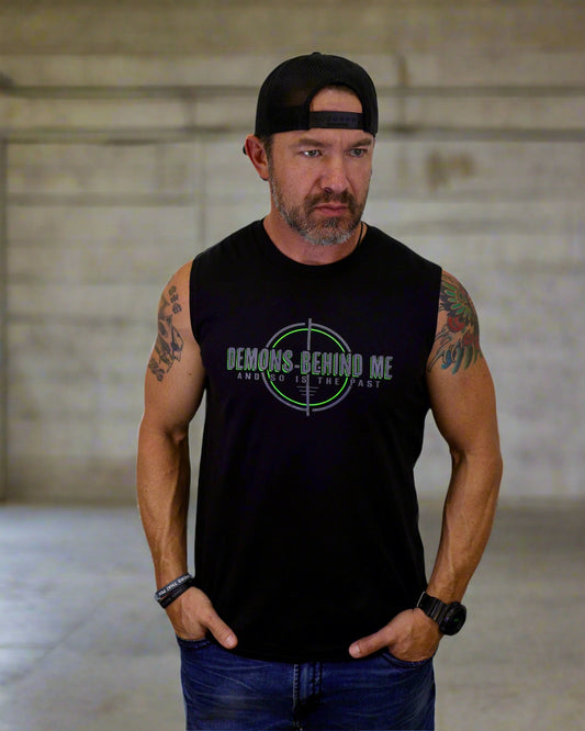 Man wearing a black sleeveless shirt with a graphic design on a white background