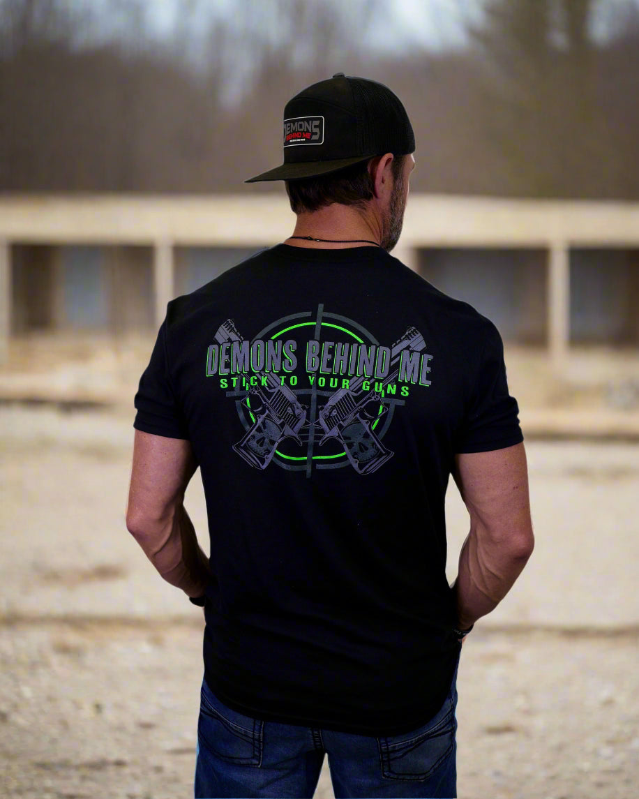 Man wearing a black t-shirt with text and graphics on the back, standing against a white background.