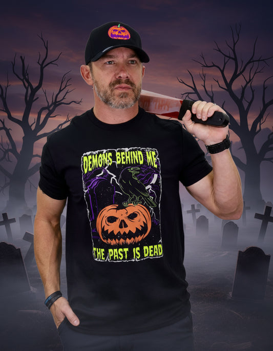 Man wearing a black t-shirt with Halloween-themed design and holding a knife.
