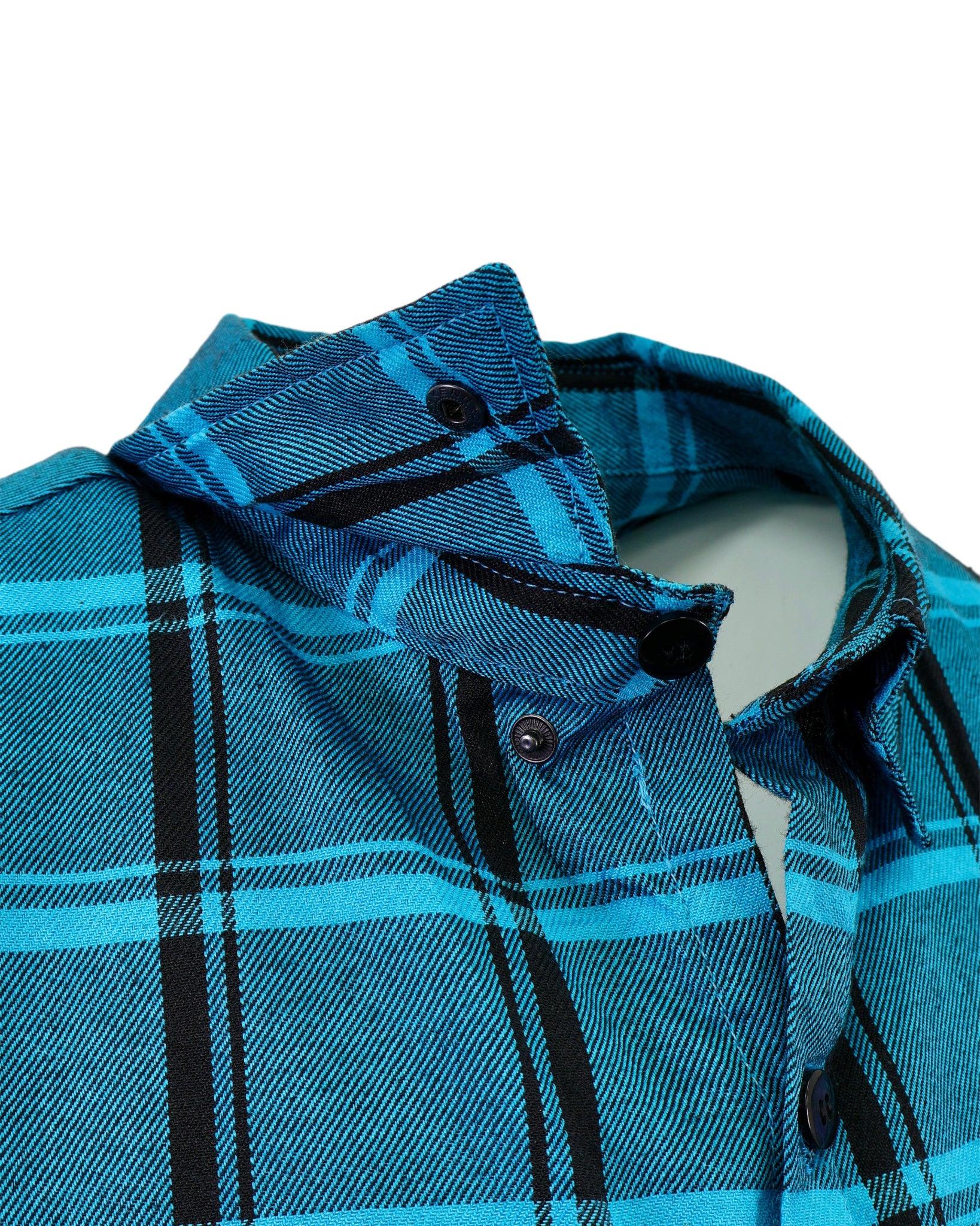 Close-up of a blue plaid shirt with black accents on a white background