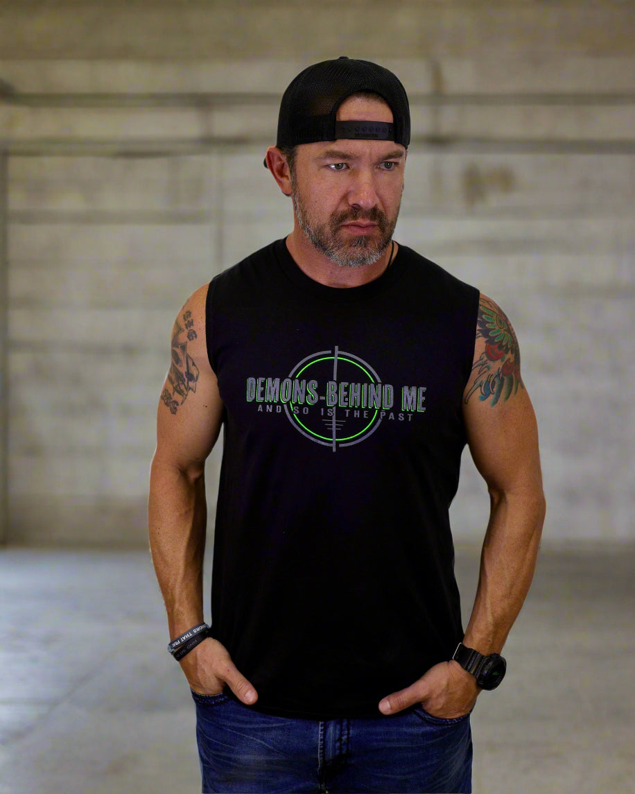 Man wearing a black sleeveless shirt with a graphic design on a white background