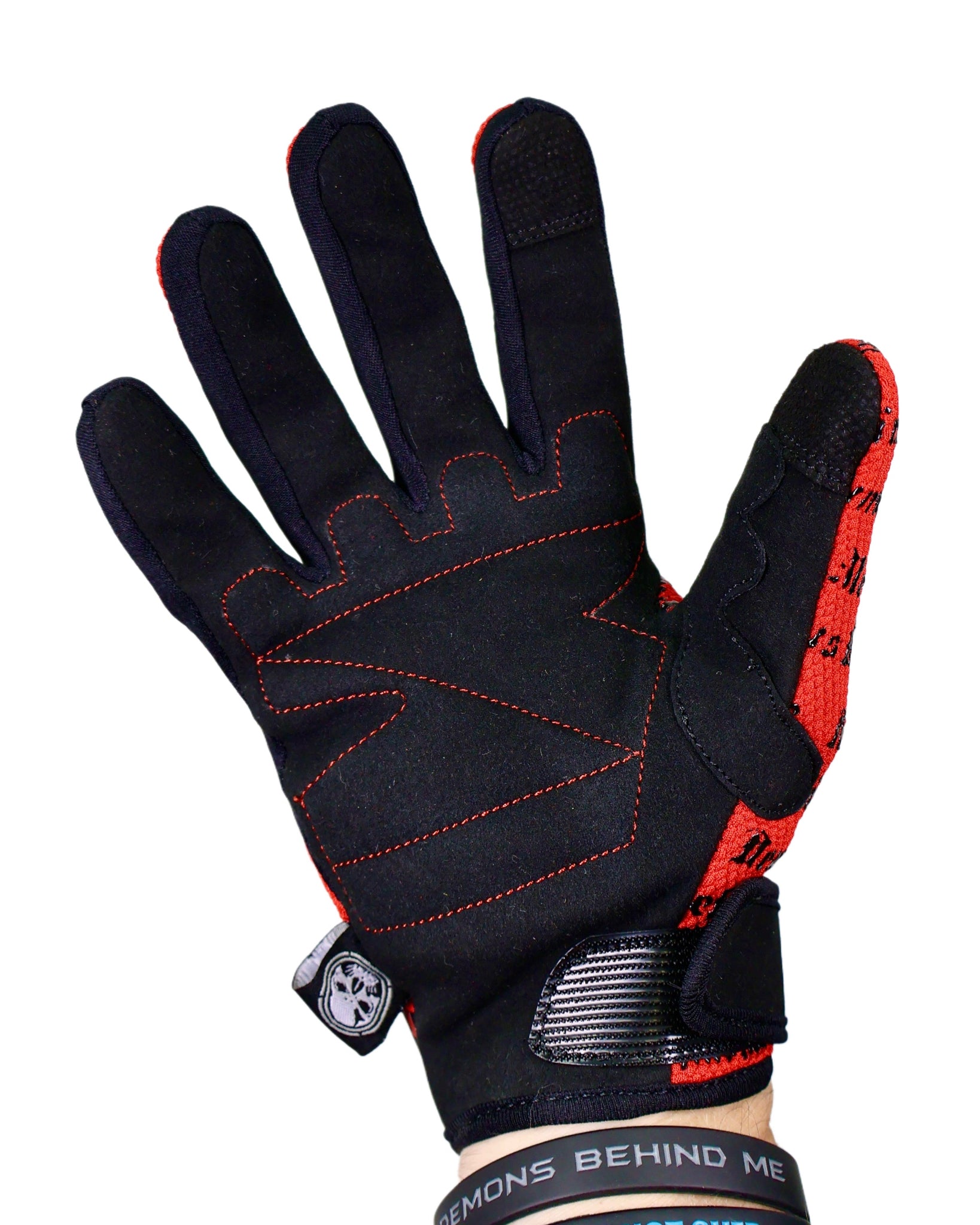 Black and red glove with visible branding on a white background
