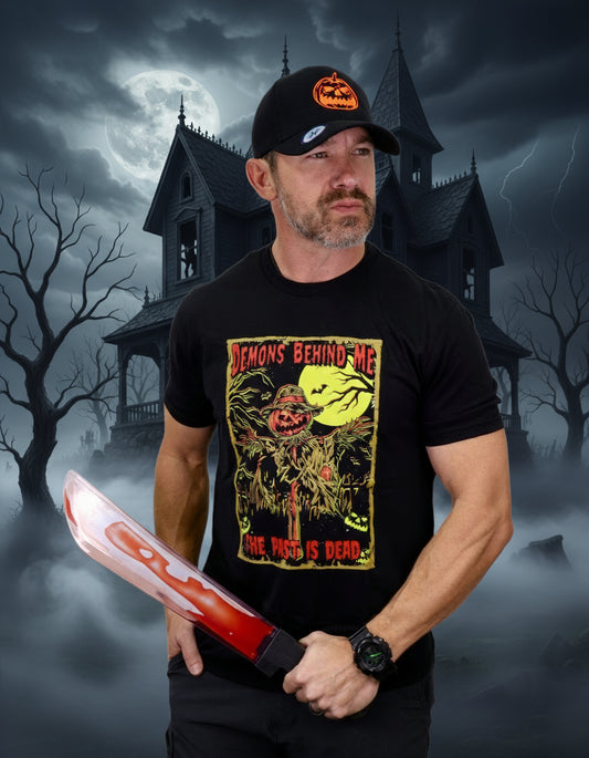 Man wearing a black t-shirt with a graphic design and holding a red and white weapon on a white background