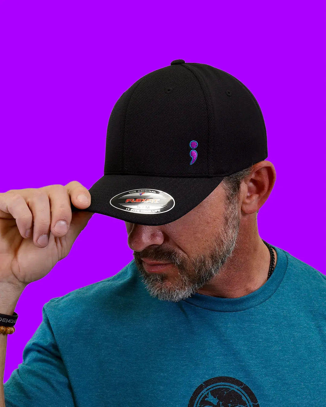 Man wearing black “Never Fade” semicolon suicide prevention cap