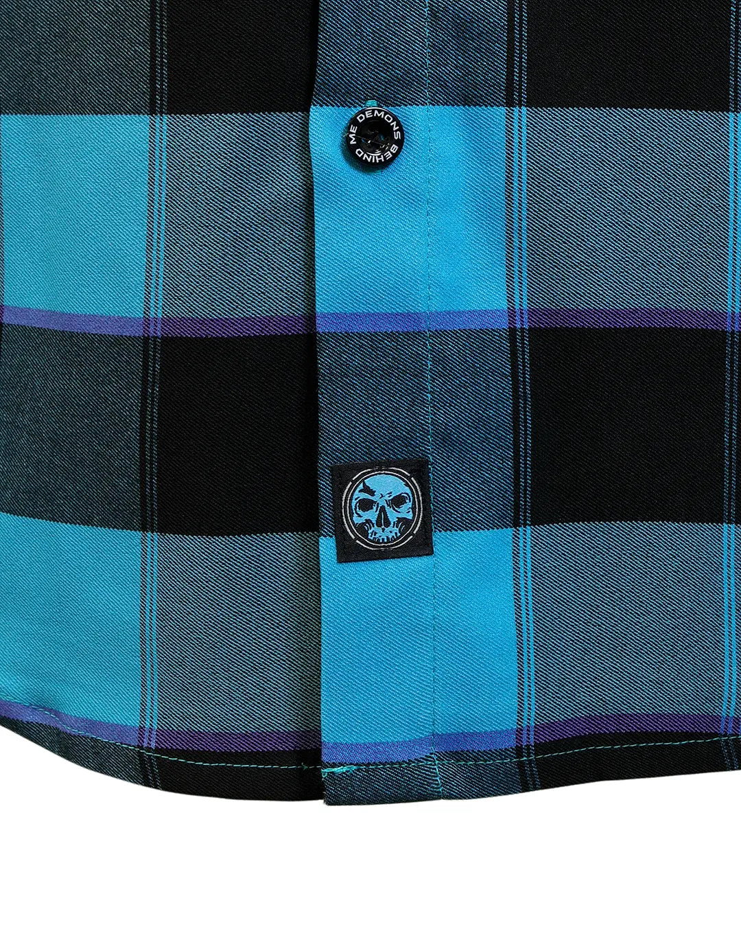 Hem detail of “Survivor 2.0” flannel with DBM skull patch and branded button