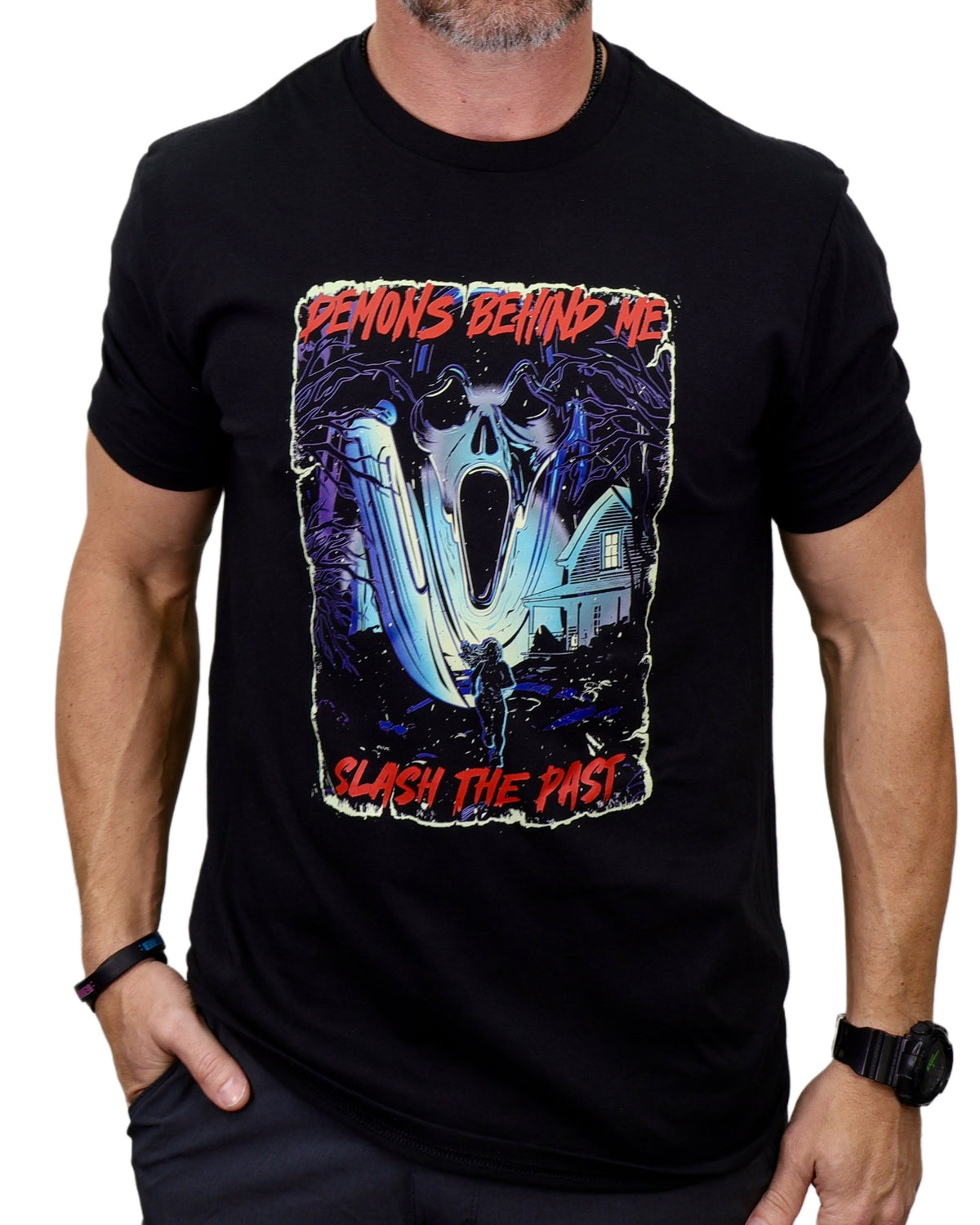 Black t-shirt with a graphic design featuring a skull and text, worn by a person.