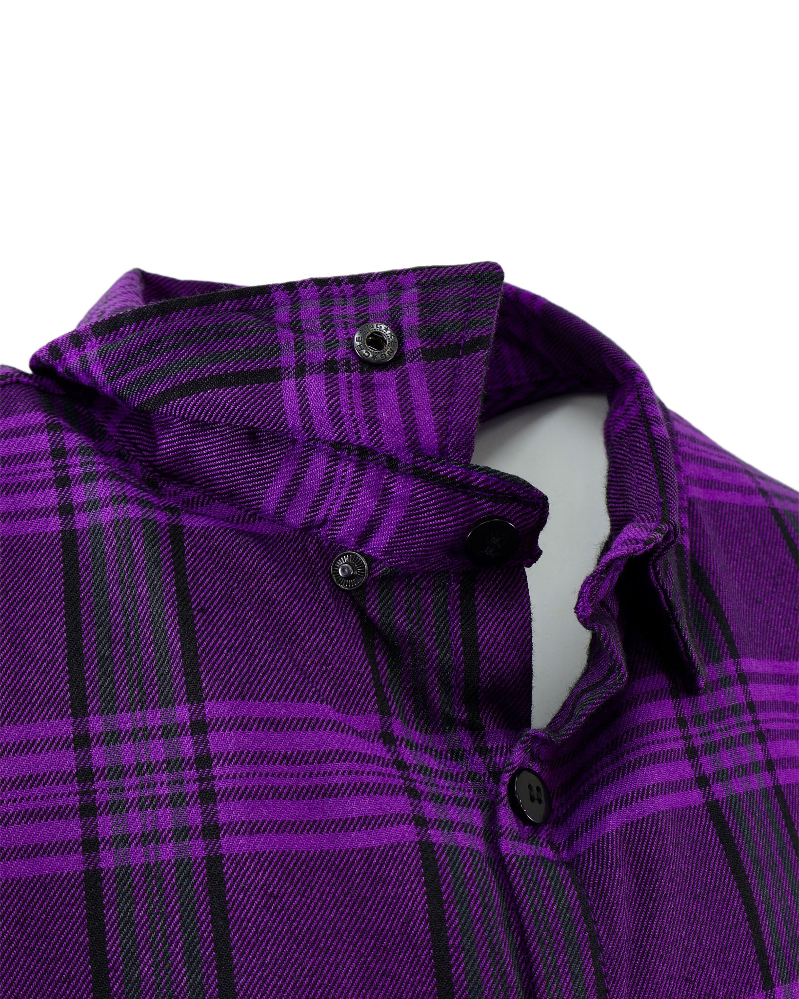 Close-up of a purple plaid shirt with collar and buttons on a white background
