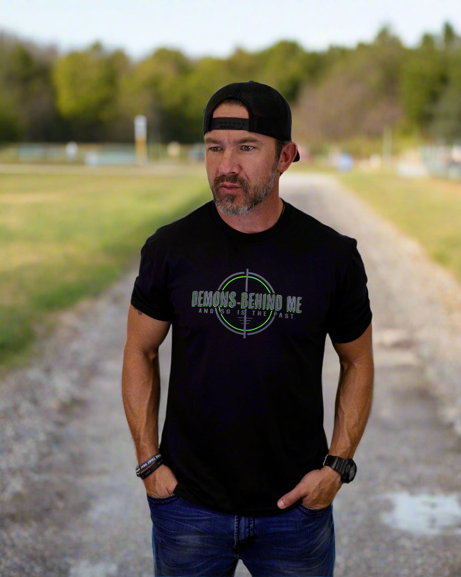 Man wearing a black t-shirt with text and graphics on a white background