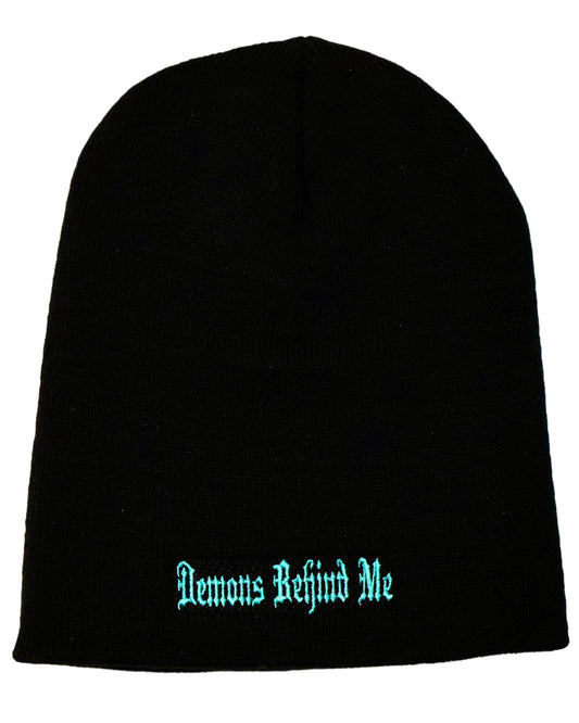 Back of black beanie with teal 'Demons Behind Me' stitching, shot against a white background.