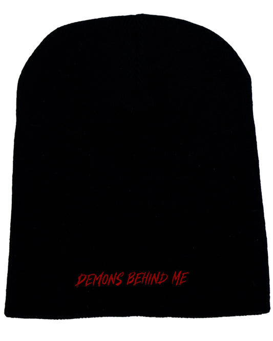 Back of black beanie with red 'Demons Behind Me' stitching, shot against a white background.