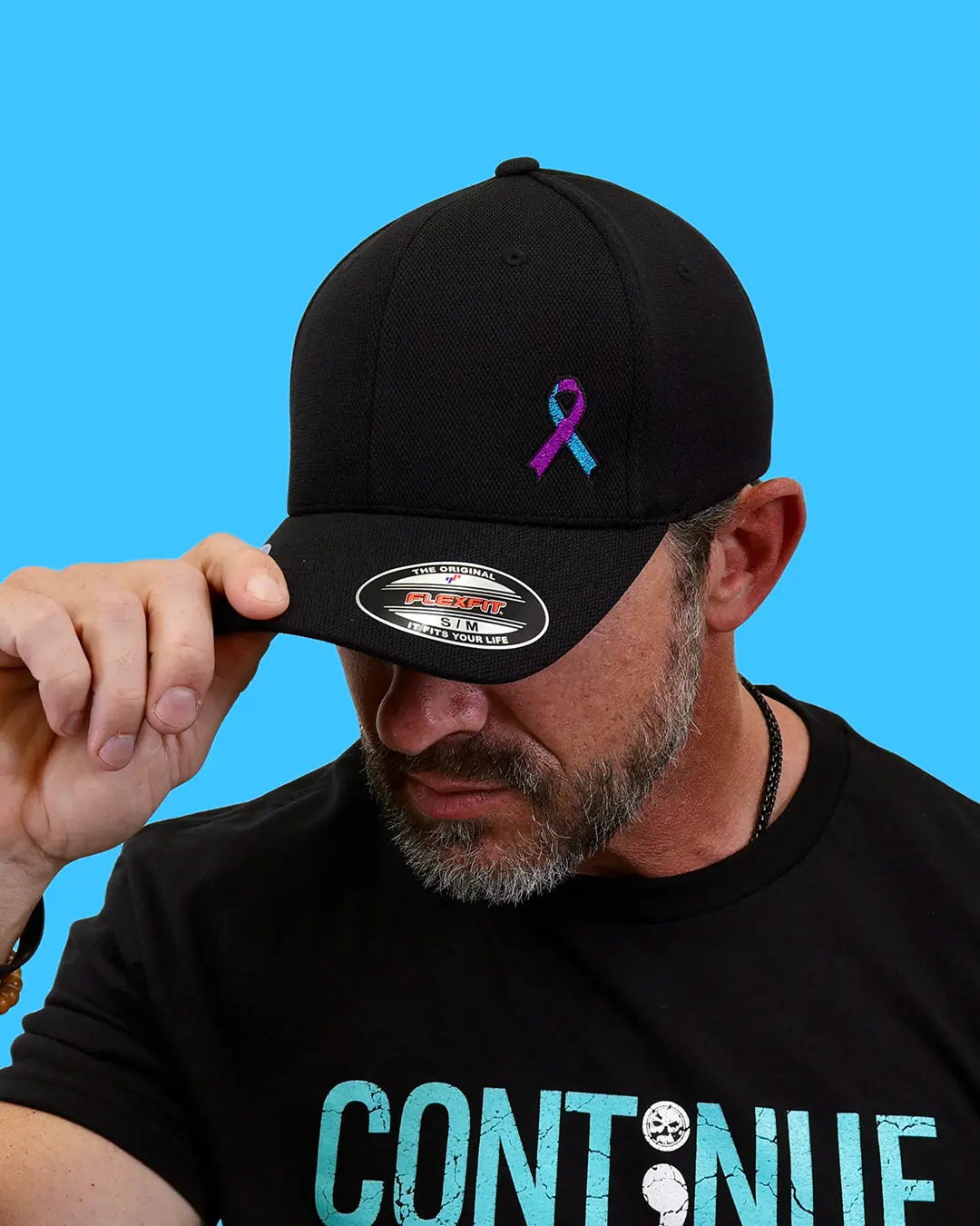 Man wearing black “Never Fade” suicide prevention ribbon cap