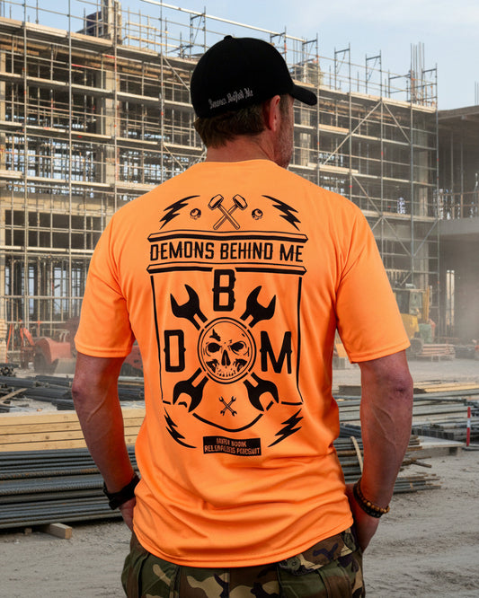 Person wearing an orange t-shirt with a black graphic design on the back, standing against a white background.