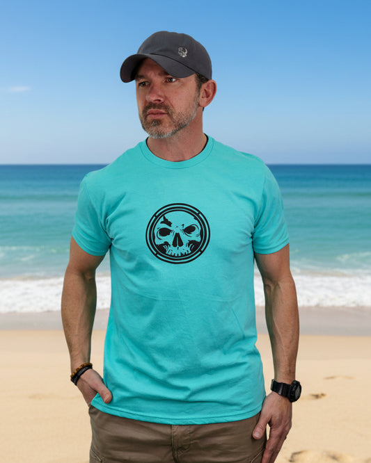 Man wearing a turquoise t-shirt with a black skull design on a white background