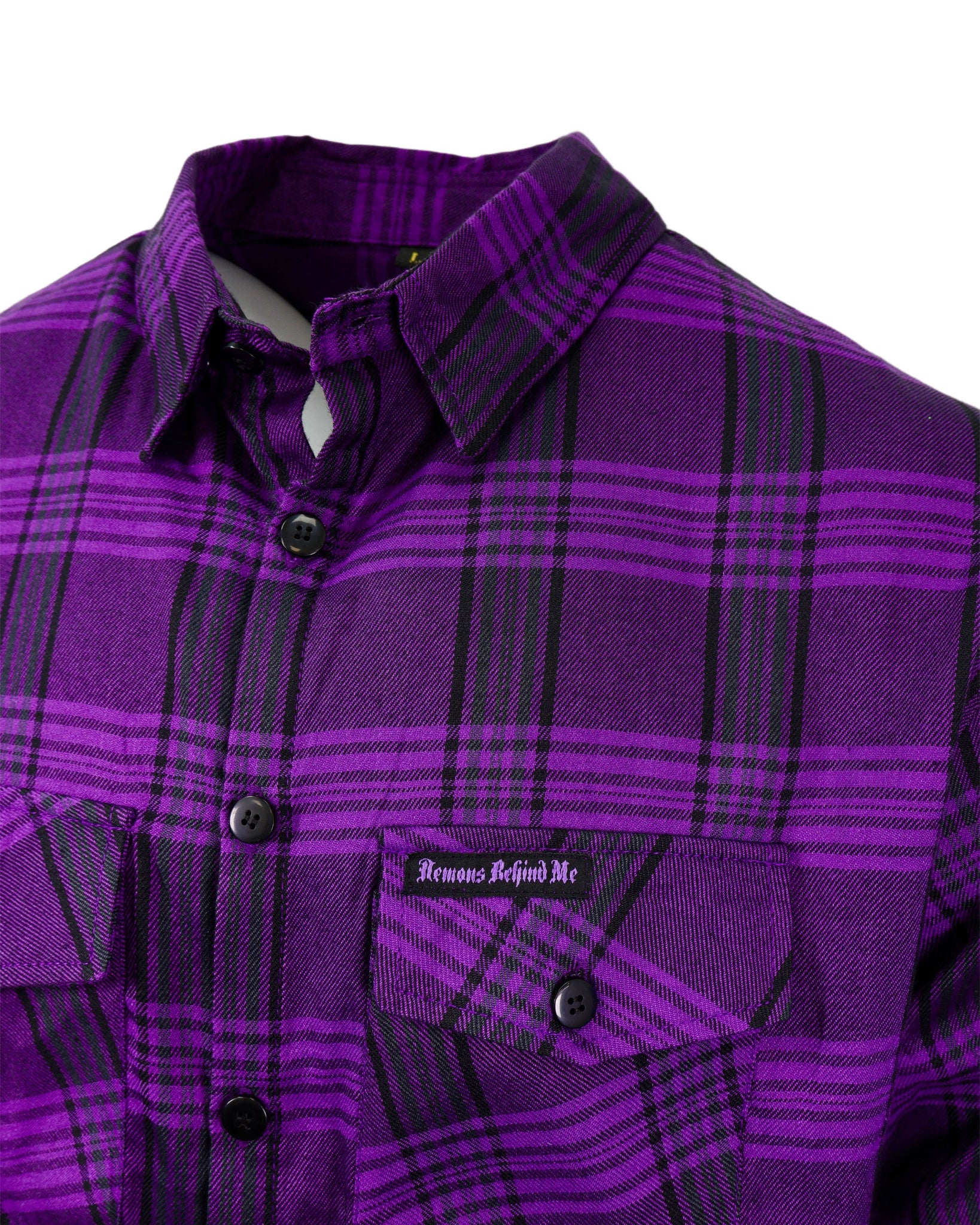Purple plaid shirt with a brand label on a white background