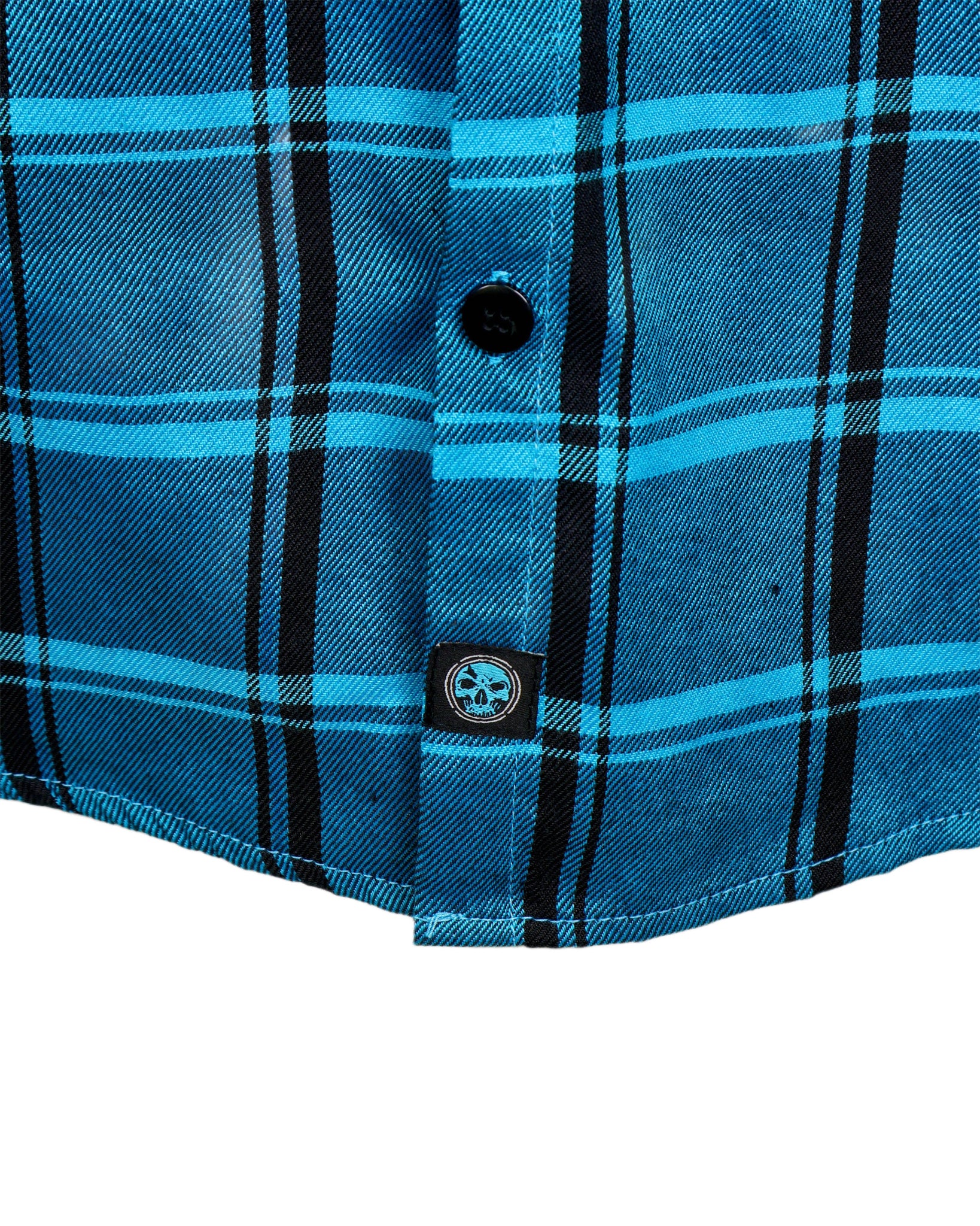 Close-up of a blue plaid shirt with a button and brand logo on a white background