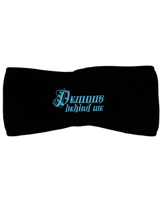 Black ear warmer headband with blue 'Demons Behind Me' stitching, shot against a white background.