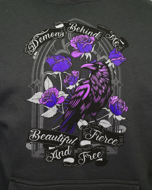 Black hoodie with a purple raven and roses design on a dark background