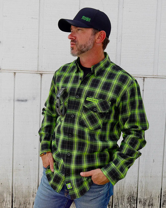 Model wearing the “Resurgence” 2.0 green and black plaid flannel, angled front view