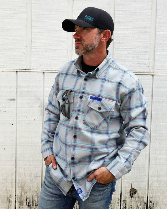 Model wearing the “Blueprint” gray, blue and purple plaid flannel, angled front view
