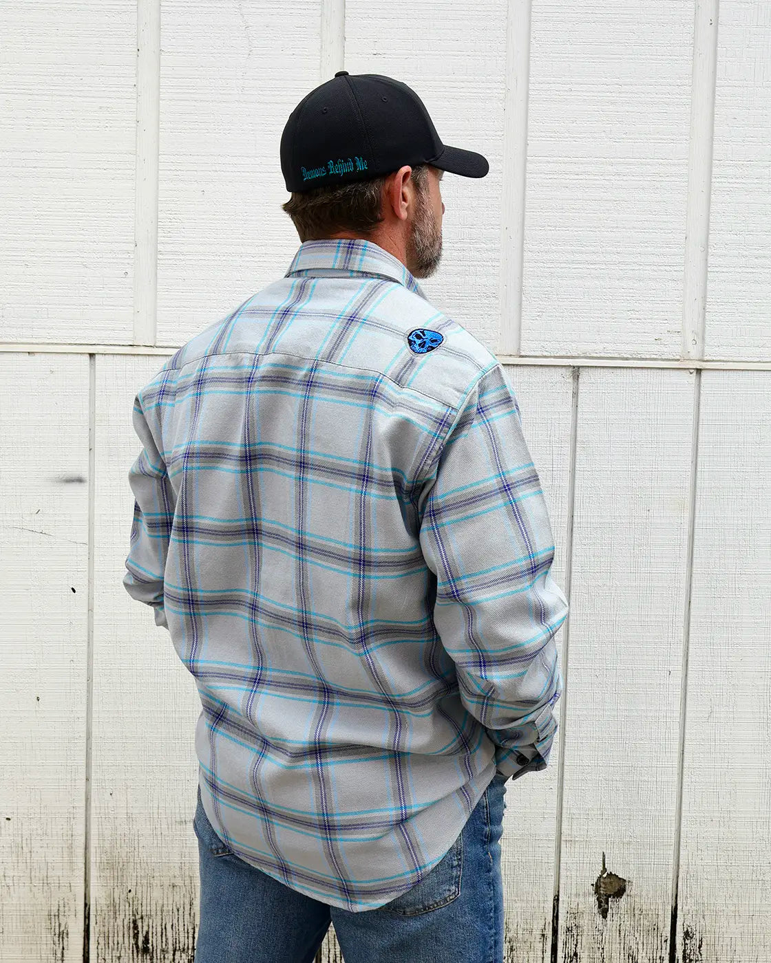 Model wearing the “Blueprint” gray, blue and purple plaid flannel, rear view