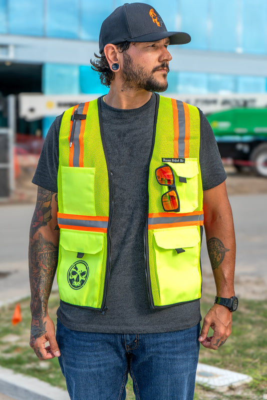 Man wearing a high-visibility safety vest with reflective stripes outdoors.